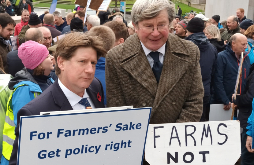 Alex holding a sign at the rally.