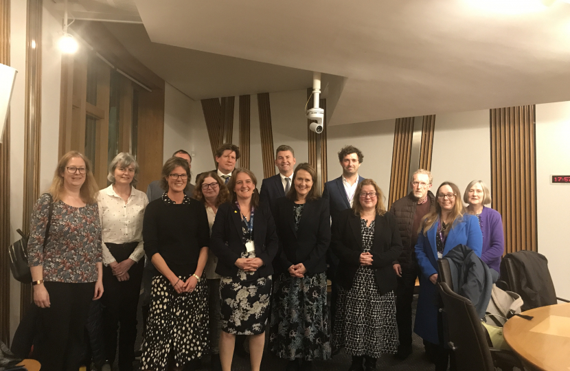 Alex stands with members of the Neurological Alliance of Scotland, MEAction Scotland, Cerebral Palsy Scotland, Epilepsy Scotland, Alzheimer Scotland, Parkinson's UK in Scotland, Headway Dundee & Angus, and Headway East Lothian.