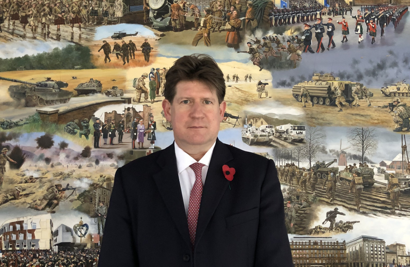 MSP Alexander Burnett in front of veteran painting